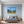 Leinwandbild Alpenlandschaft mit blühenden Wiesen fuer Schlafzimmer blau Querformat