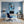 Leinwandbild Verspielter Schimpanse im Wasser fuer Buero und Arbeitszimmer blau Hochformat