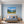 Poster Wandbild Alpenlandschaft mit blühenden Wiesen fuer Schlafzimmer blau Querformat