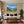Poster Wandbild Alpenlandschaft mit blühenden Wiesen fuer Wohnzimmer warmeFarben Querformat