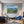 Poster Wandbild Berglandschaft im Sommer fuer Wohnzimmer blau Querformat