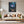 Poster Wandbild Leuchtende Blüte im Wald fuer Wohnzimmer grauoderbeige Hochformat