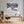 Poster Wandbild Schneeleopard im Winterwunderland fuer Büro- und Arbeitszimmer warmeFarben Querformat