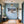 Poster Wandbild Schneeleopard im Winterwunderland fuer Flur und Eingang blau Querformat