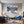 Poster Wandbild Schneeleopard im Winterwunderland fuer Wohnzimmer blau Querformat