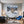 Poster Wandbild Schneeleopard im Winterwunderland fuer Wohnzimmer blau Querformat