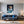 Poster Wandbild Verspielter Leopard im Wasser fuer Wohnzimmer blau Hochformat