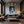 Poster Wandbild Verspielter Leopard im Wasser fuer Wohnzimmer dunkelanthrazit Hochformat